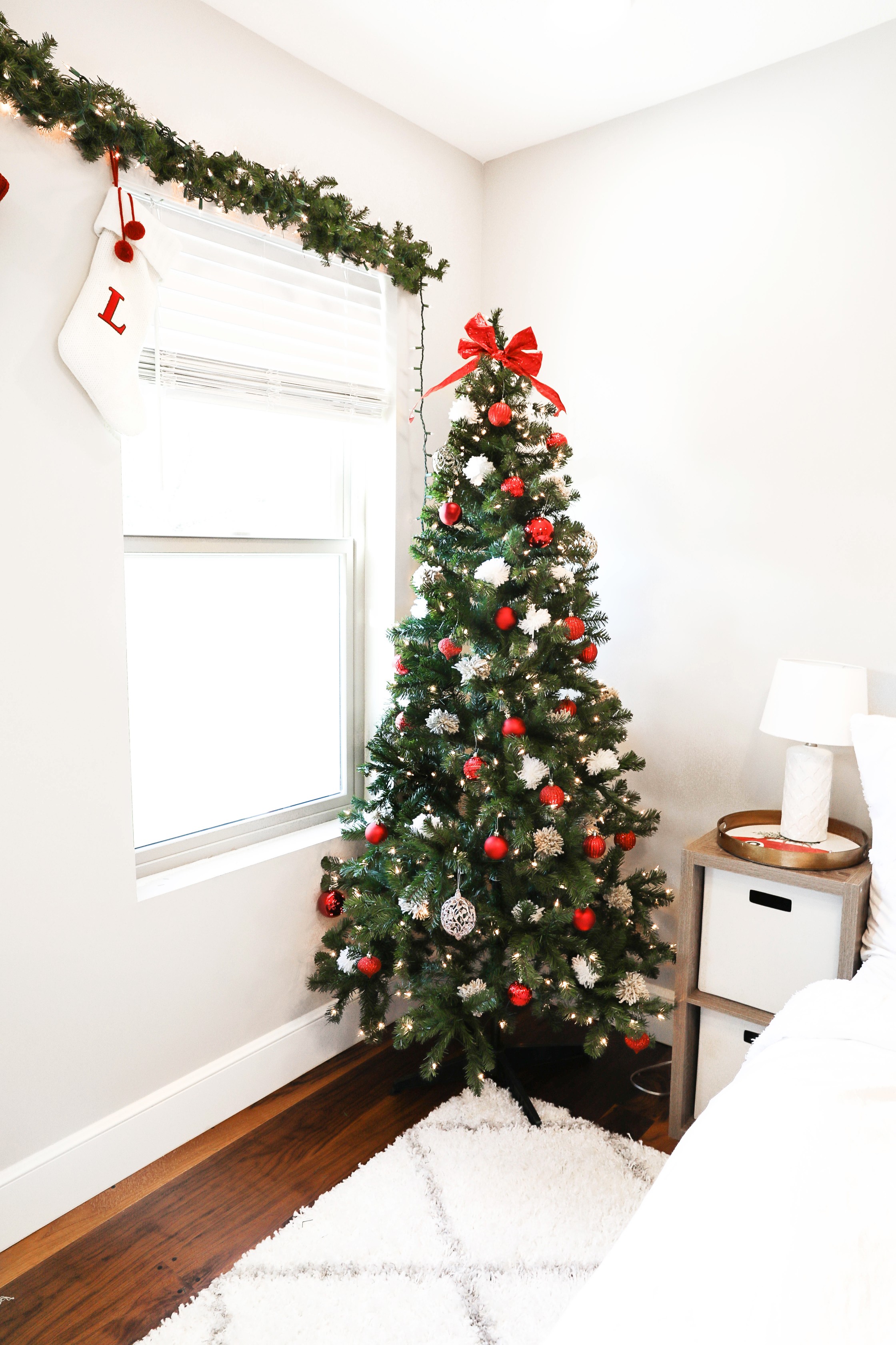 Holiday room decor! Decorate my apartment for Christmas with me! I blogged my adorable white, red, and green christmas tree! I also hung up some cute, inexpensive garland! Cutest white room decorations! Get all the details on fashion blog daily dose of charm by lauren lindmark