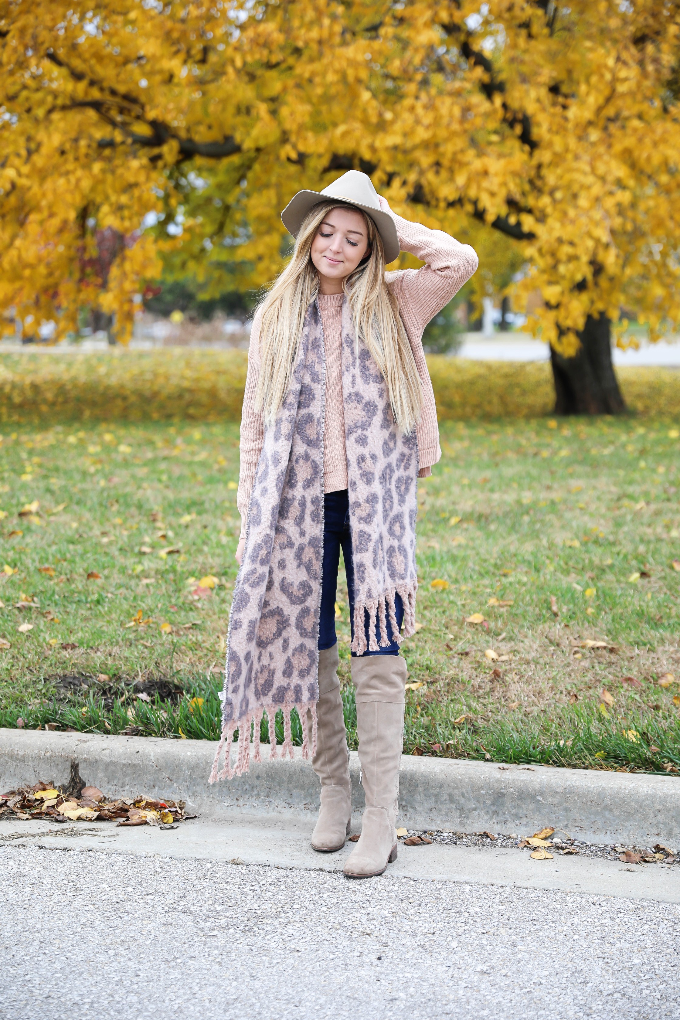 Pink and grey leopard scarf paired with a cute cream Madewell sweater! This sweater has the cutest pockets! I paired the fall look with denim jeans, Vince Camuto over the knee boots, and my tan felt hat! Details on fashion blog daily dose of charm by lauren lindmark