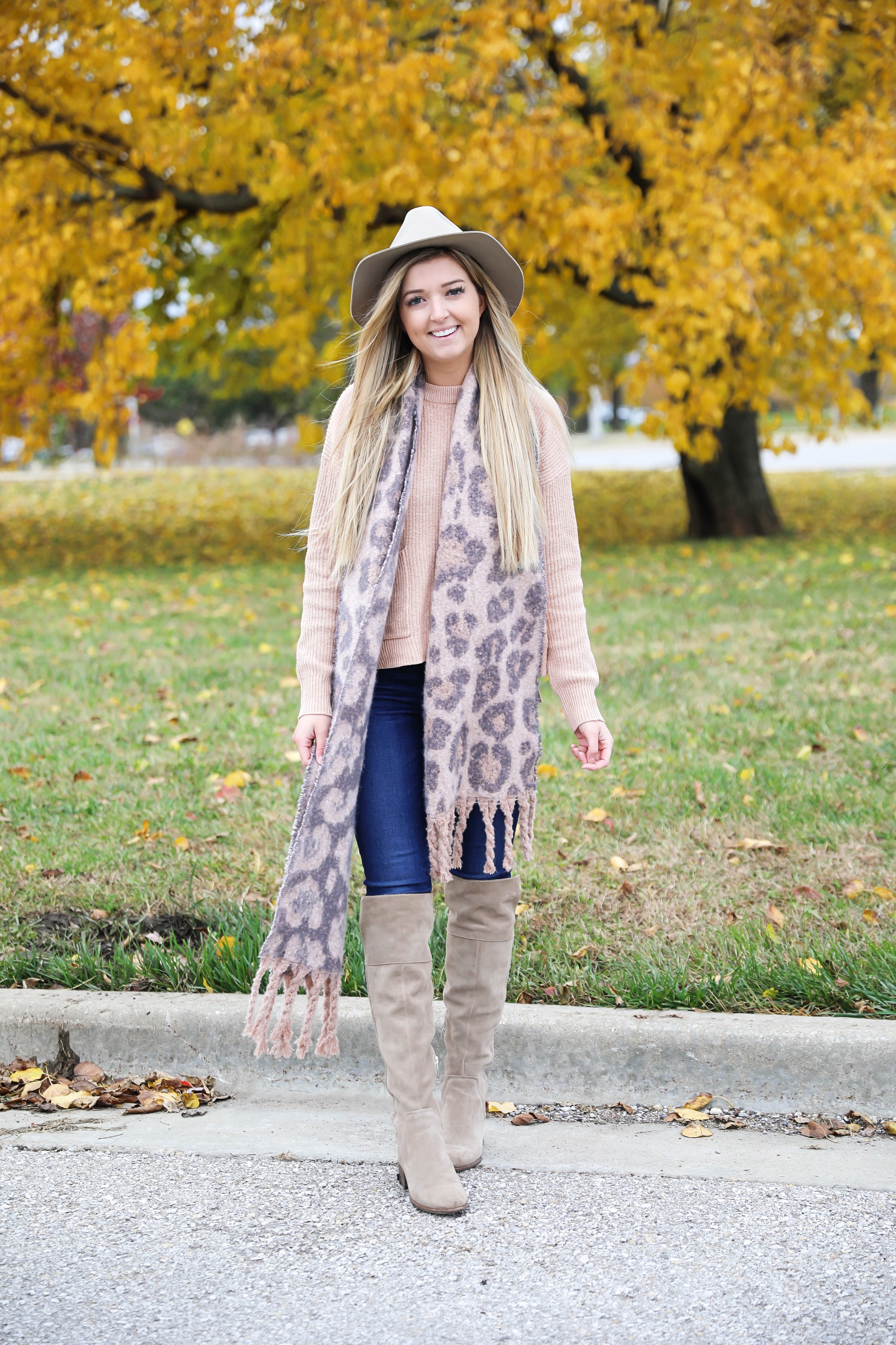 Pink and grey leopard scarf paired with a cute cream Madewell sweater! This sweater has the cutest pockets! I paired the fall look with denim jeans, Vince Camuto over the knee boots, and my tan felt hat! Details on fashion blog daily dose of charm by lauren lindmark