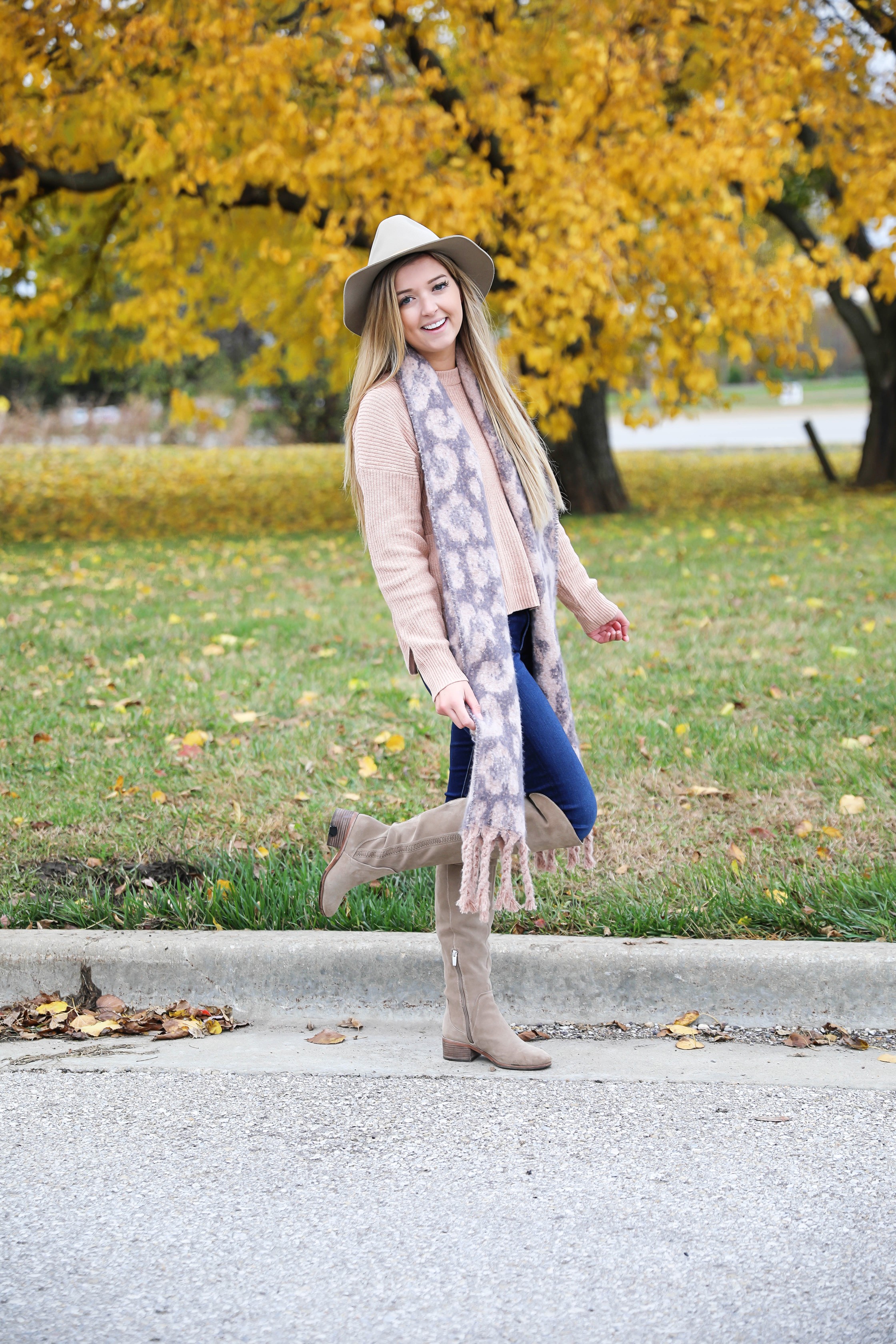 Pink and grey leopard scarf paired with a cute cream Madewell sweater! This sweater has the cutest pockets! I paired the fall look with denim jeans, Vince Camuto over the knee boots, and my tan felt hat! Details on fashion blog daily dose of charm by lauren lindmark