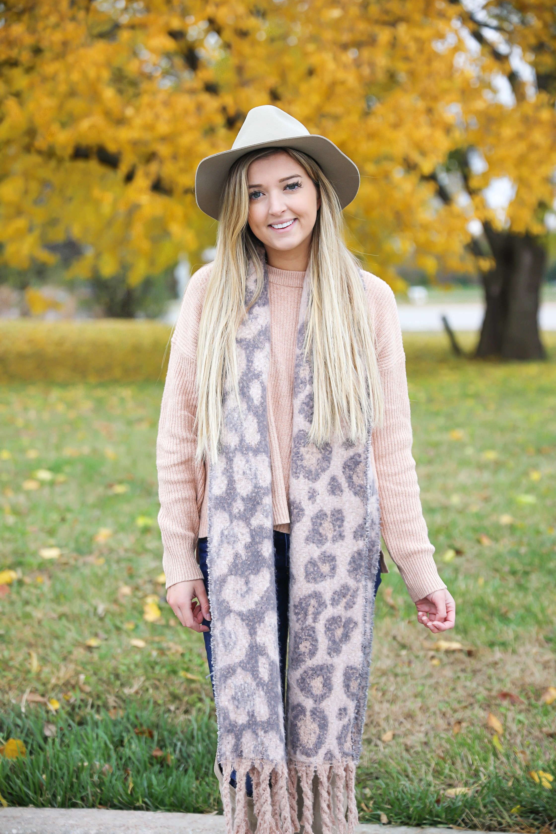 Pink and grey leopard scarf paired with a cute cream Madewell sweater! This sweater has the cutest pockets! I paired the fall look with denim jeans, Vince Camuto over the knee boots, and my tan felt hat! Details on fashion blog daily dose of charm by lauren lindmark