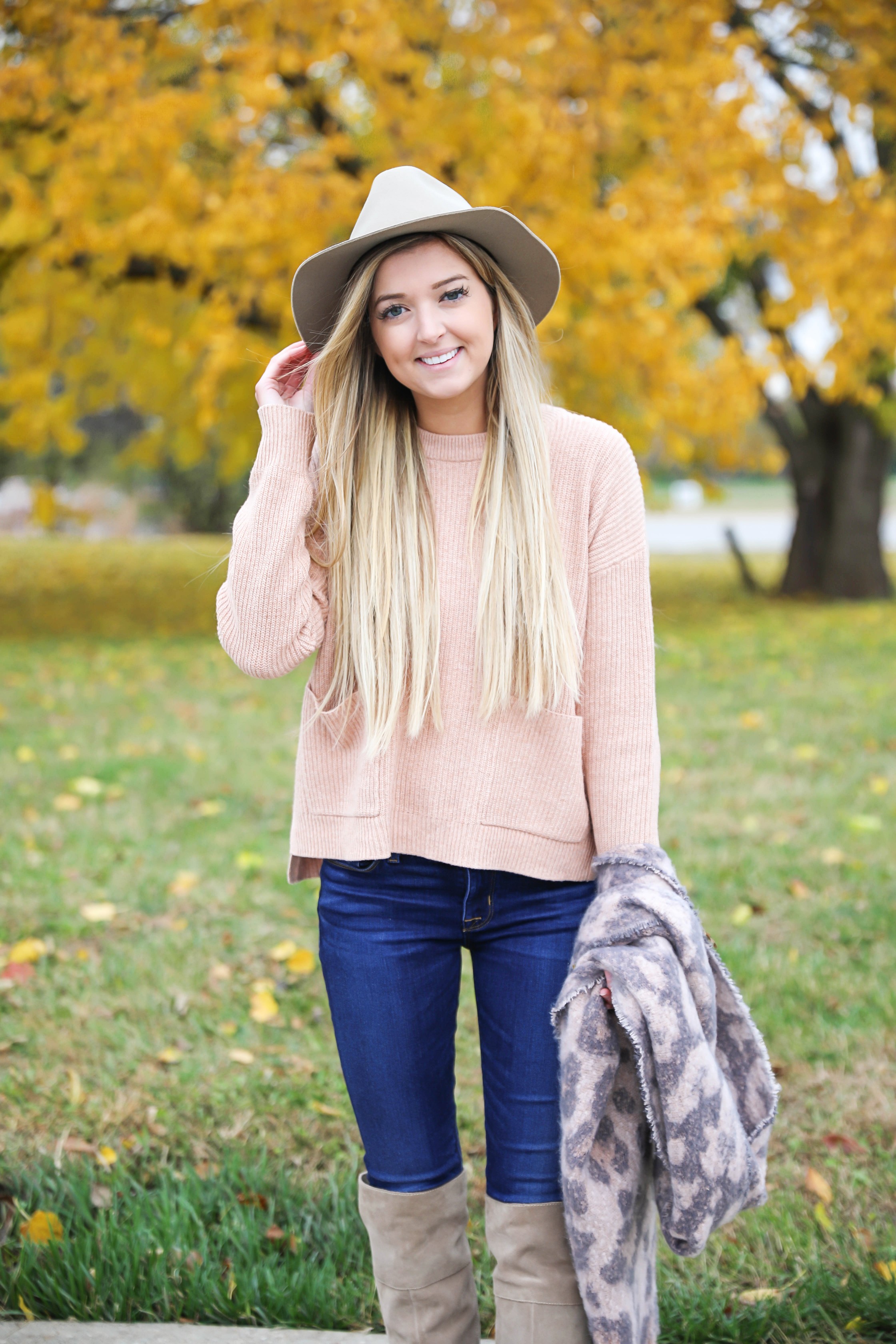 Pink and grey leopard scarf paired with a cute cream Madewell sweater! This sweater has the cutest pockets! I paired the fall look with denim jeans, Vince Camuto over the knee boots, and my tan felt hat! Details on fashion blog daily dose of charm by lauren lindmark