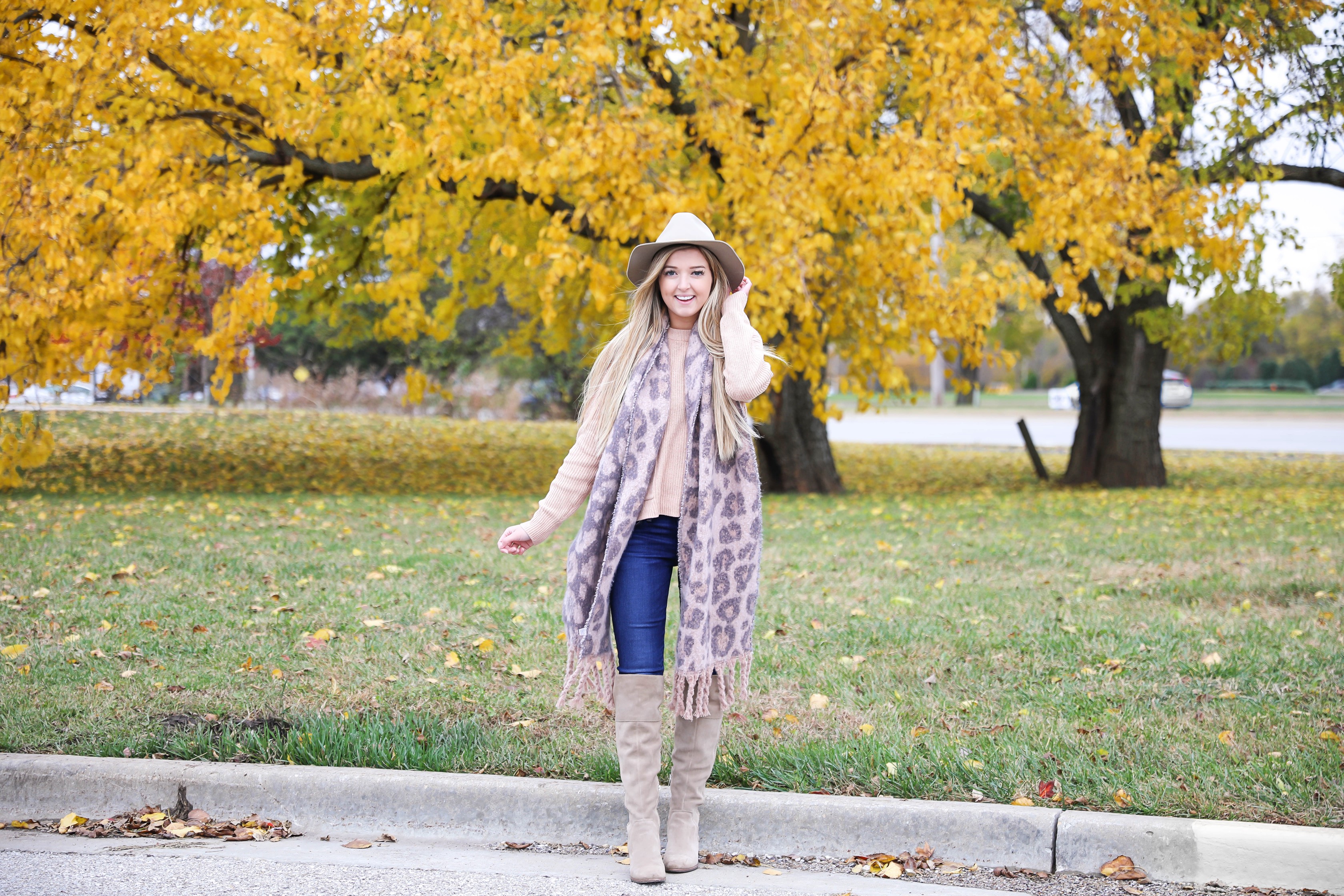 Pink and grey leopard scarf paired with a cute cream Madewell sweater! This sweater has the cutest pockets! I paired the fall look with denim jeans, Vince Camuto over the knee boots, and my tan felt hat! Details on fashion blog daily dose of charm by lauren lindmark