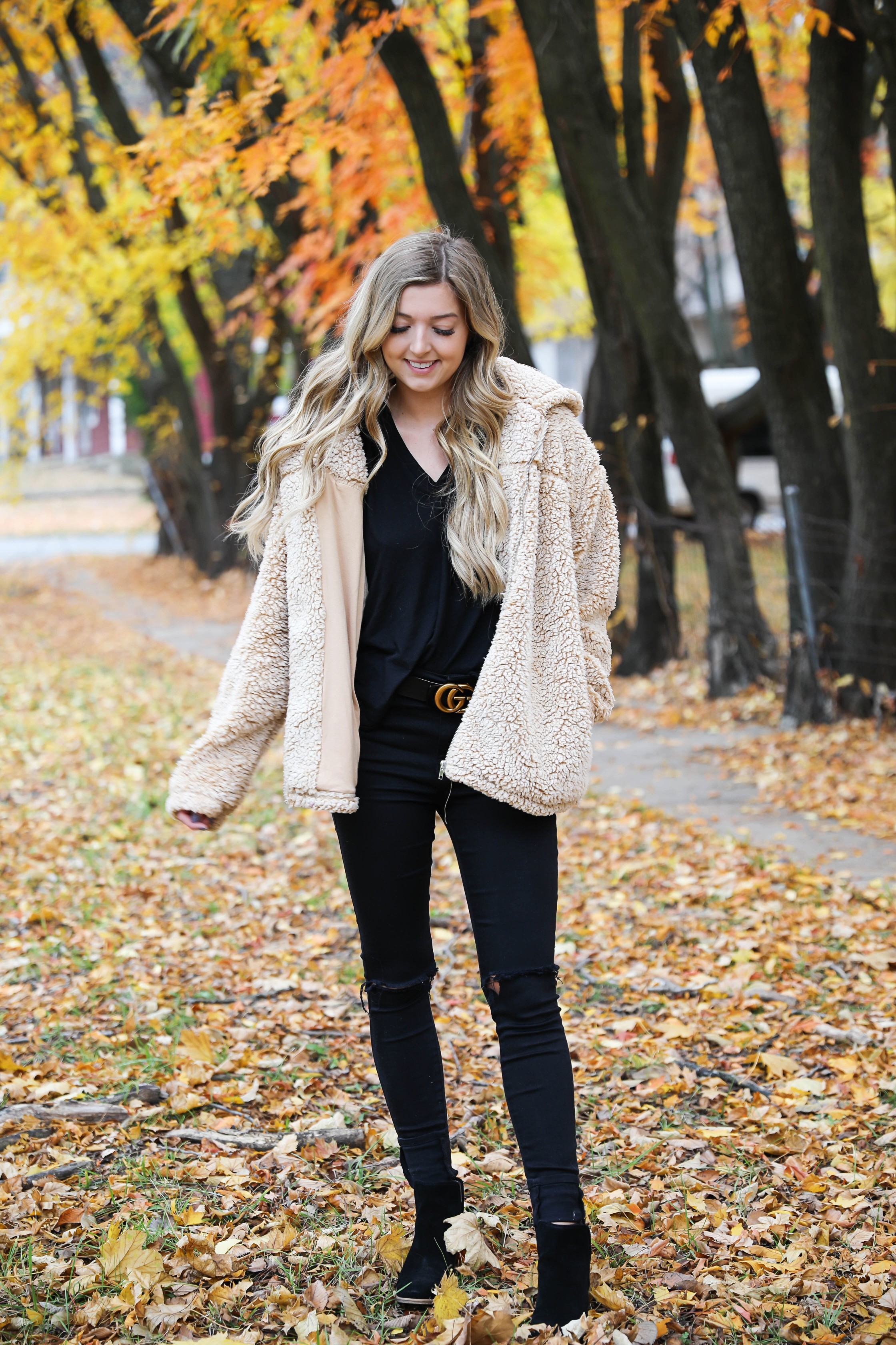 Teddy bear coat roundup! All the comfiest teddy bear fuzzy coats are linked on my blog! I paired mine with an all black outfit and my gucci belt! These are the prettiest photos taken in the fall leaves. Autumn trees are the best! Details on fashion blog daily dose of charm by lauren lindmark