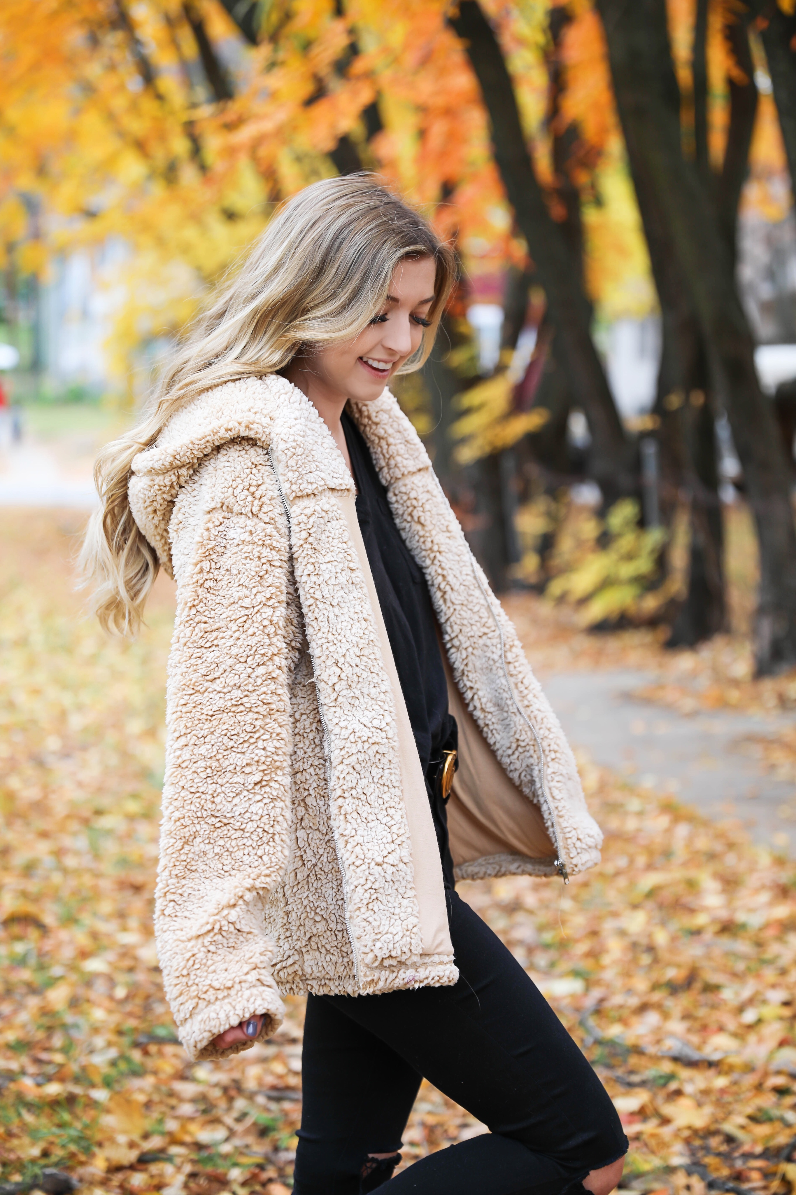 Teddy bear coat roundup! All the comfiest teddy bear fuzzy coats are linked on my blog! I paired mine with an all black outfit and my gucci belt! These are the prettiest photos taken in the fall leaves. Autumn trees are the best! Details on fashion blog daily dose of charm by lauren lindmark