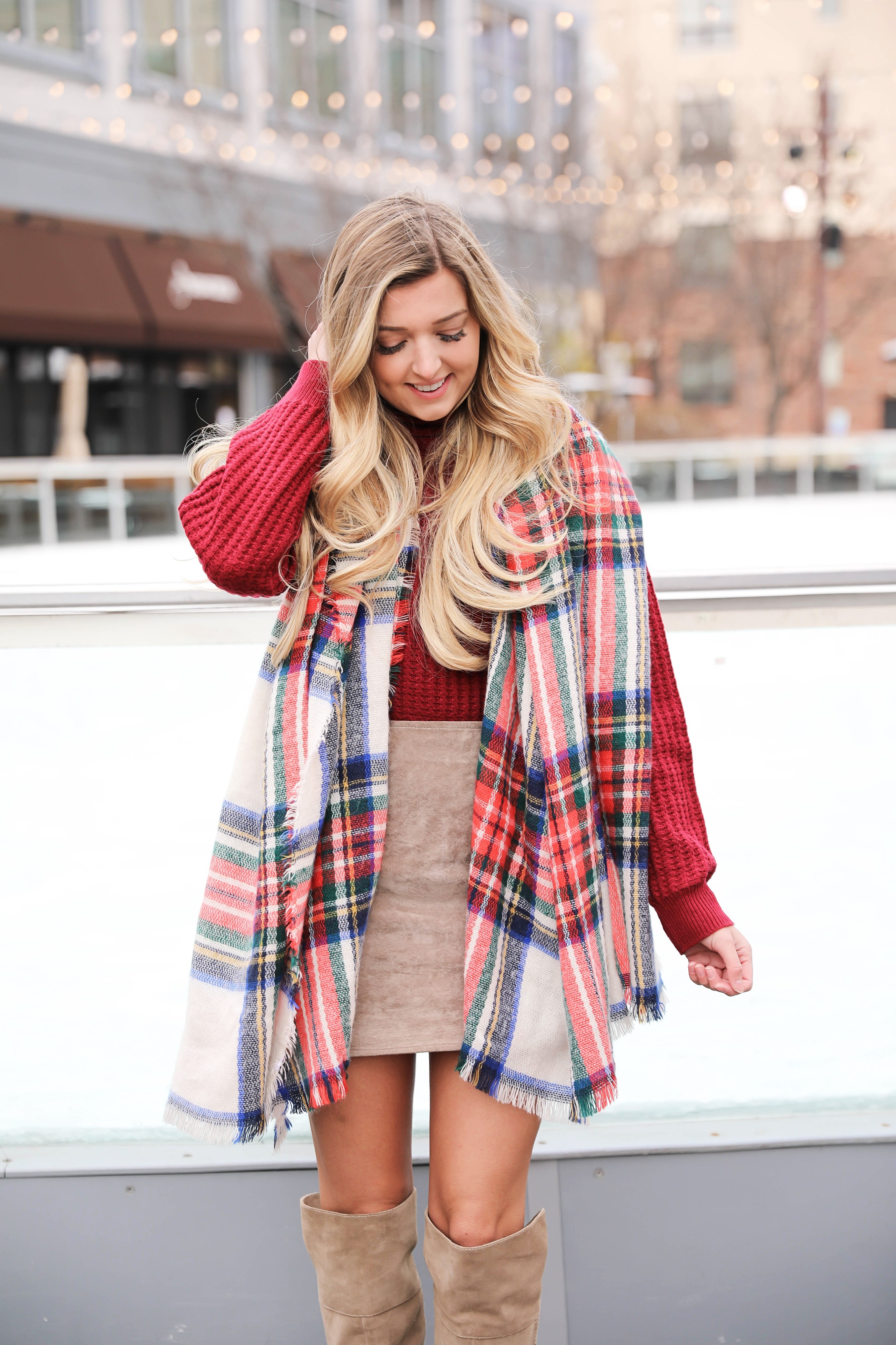 Red turtleneck sweater paired with my favorite suede skirt and Vince Camuto over the knee boots! This holiday look looks so cute with this red and green plaid scarf! The cutest winter outfit on the fashion blog daily dose of charm by lauren lindmark