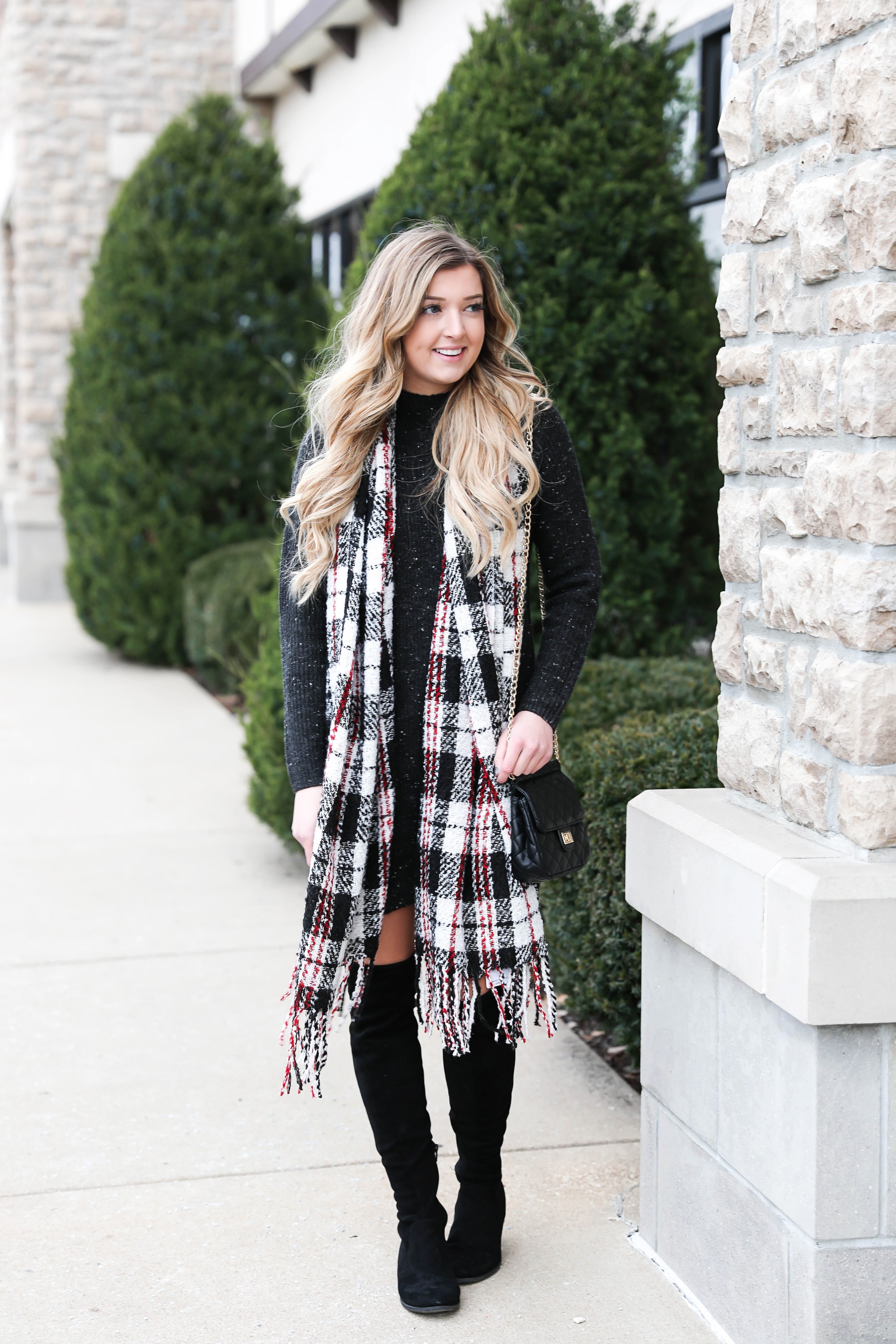 Black sweater dress paired with the cutest red plaid scarf and my favorite black over the knee boots! Cutest curly hair and winter outfit! Details on fashion blog daily dose of charm by lauren lindmark