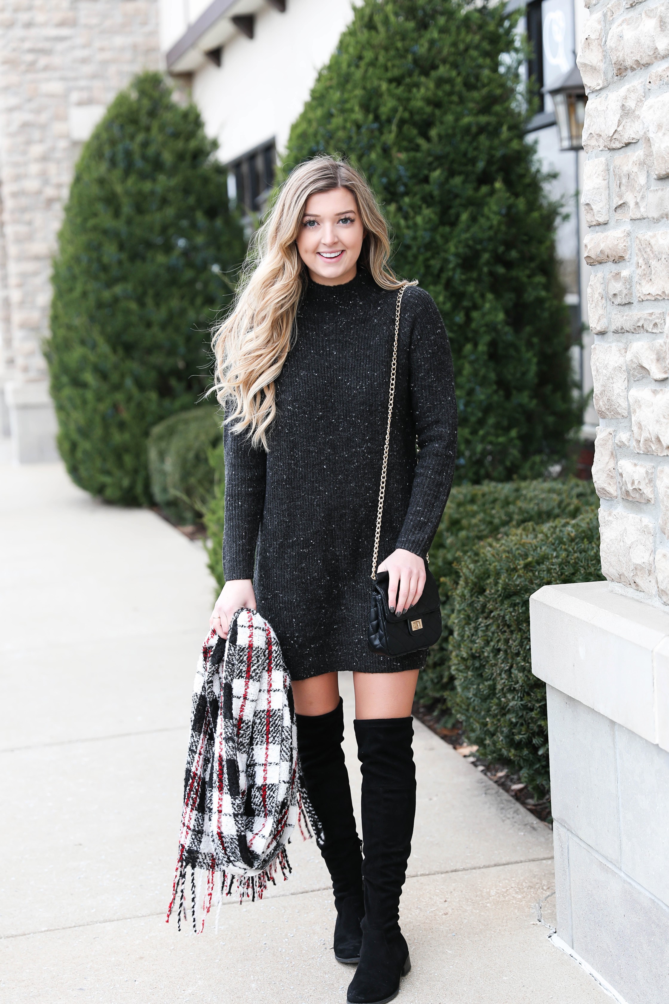 Black sweater dress paired with the cutest red plaid scarf and my favorite black over the knee boots! Cutest curly hair and winter outfit! Details on fashion blog daily dose of charm by lauren lindmark