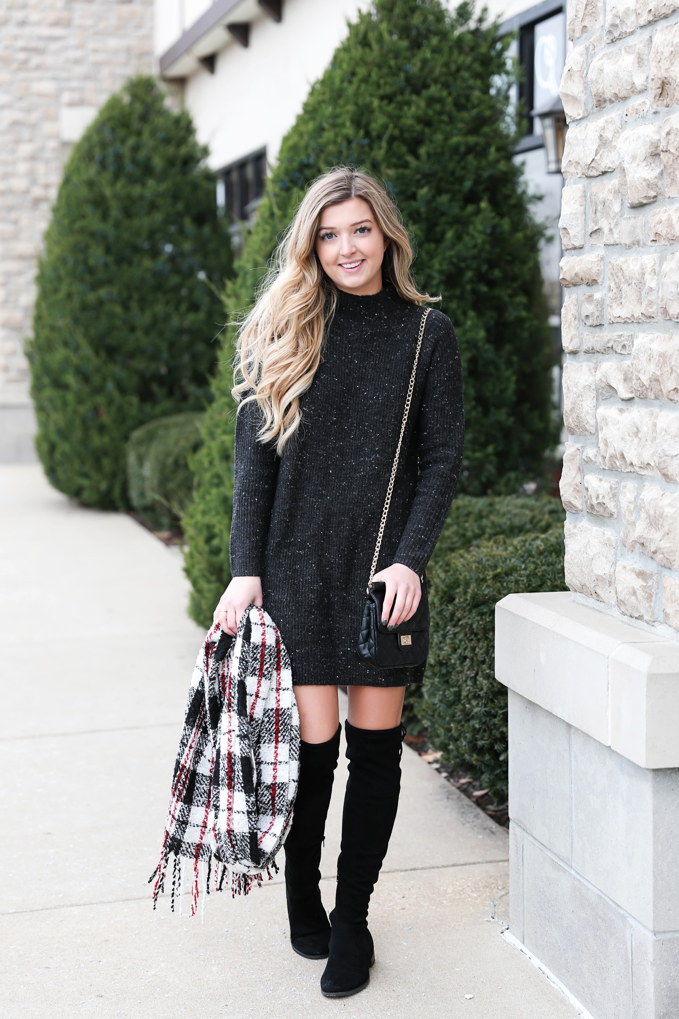Black sweater dress paired with the cutest red plaid scarf and my favorite black over the knee boots! Cutest curly hair and winter outfit! Details on fashion blog daily dose of charm by lauren lindmark