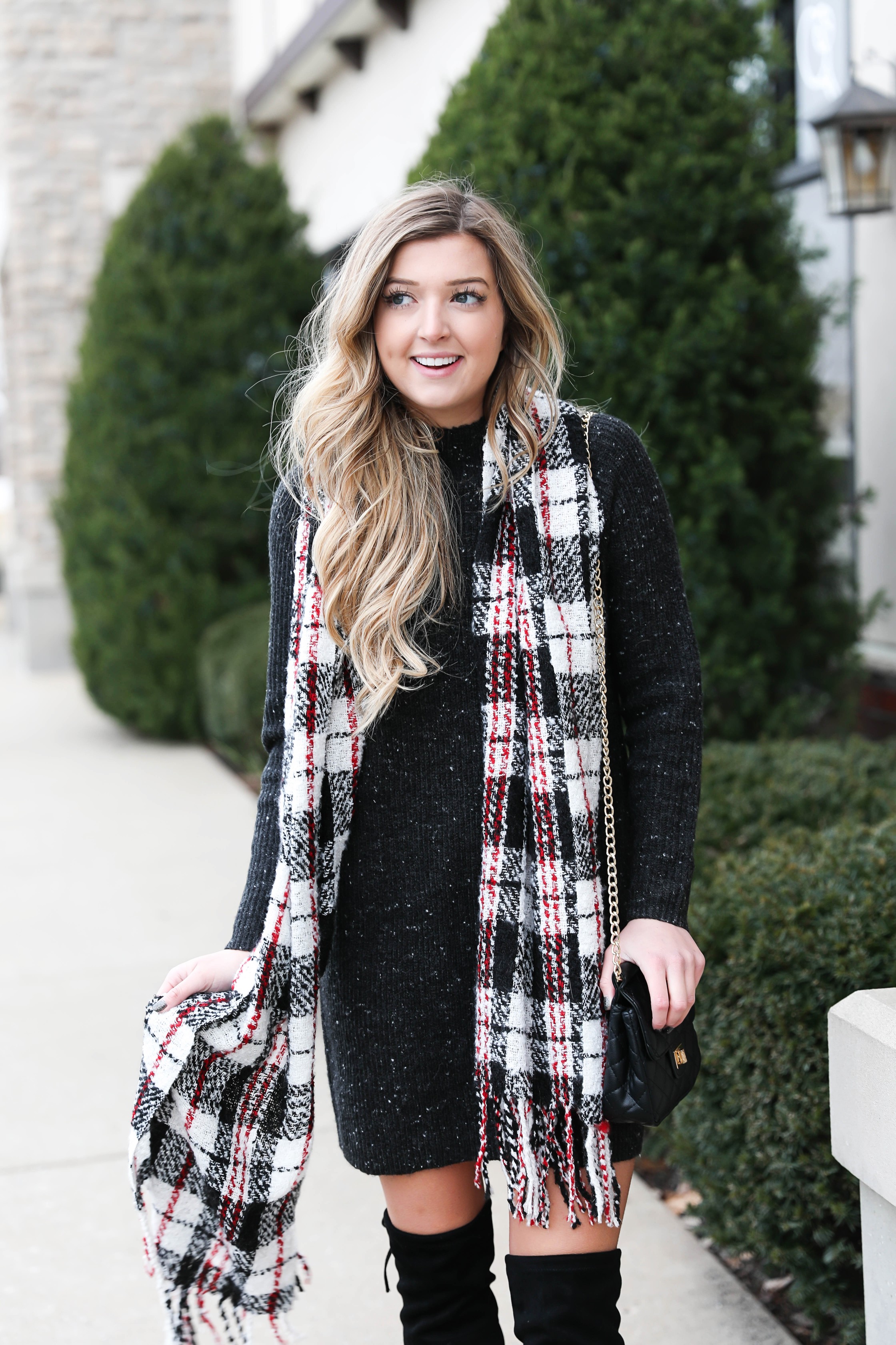 Black sweater dress paired with the cutest red plaid scarf and my favorite black over the knee boots! Cutest curly hair and winter outfit! Details on fashion blog daily dose of charm by lauren lindmark