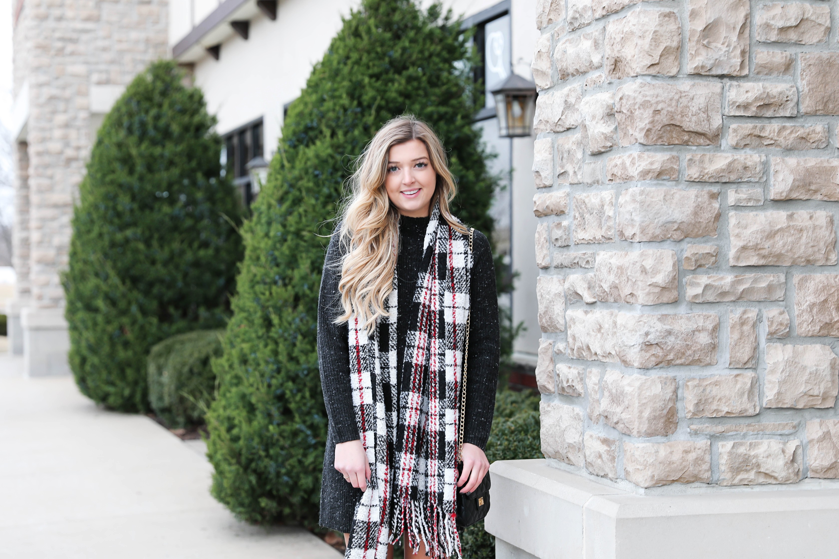 Black sweater dress paired with the cutest red plaid scarf and my favorite black over the knee boots! Cutest curly hair and winter outfit! Details on fashion blog daily dose of charm by lauren lindmark