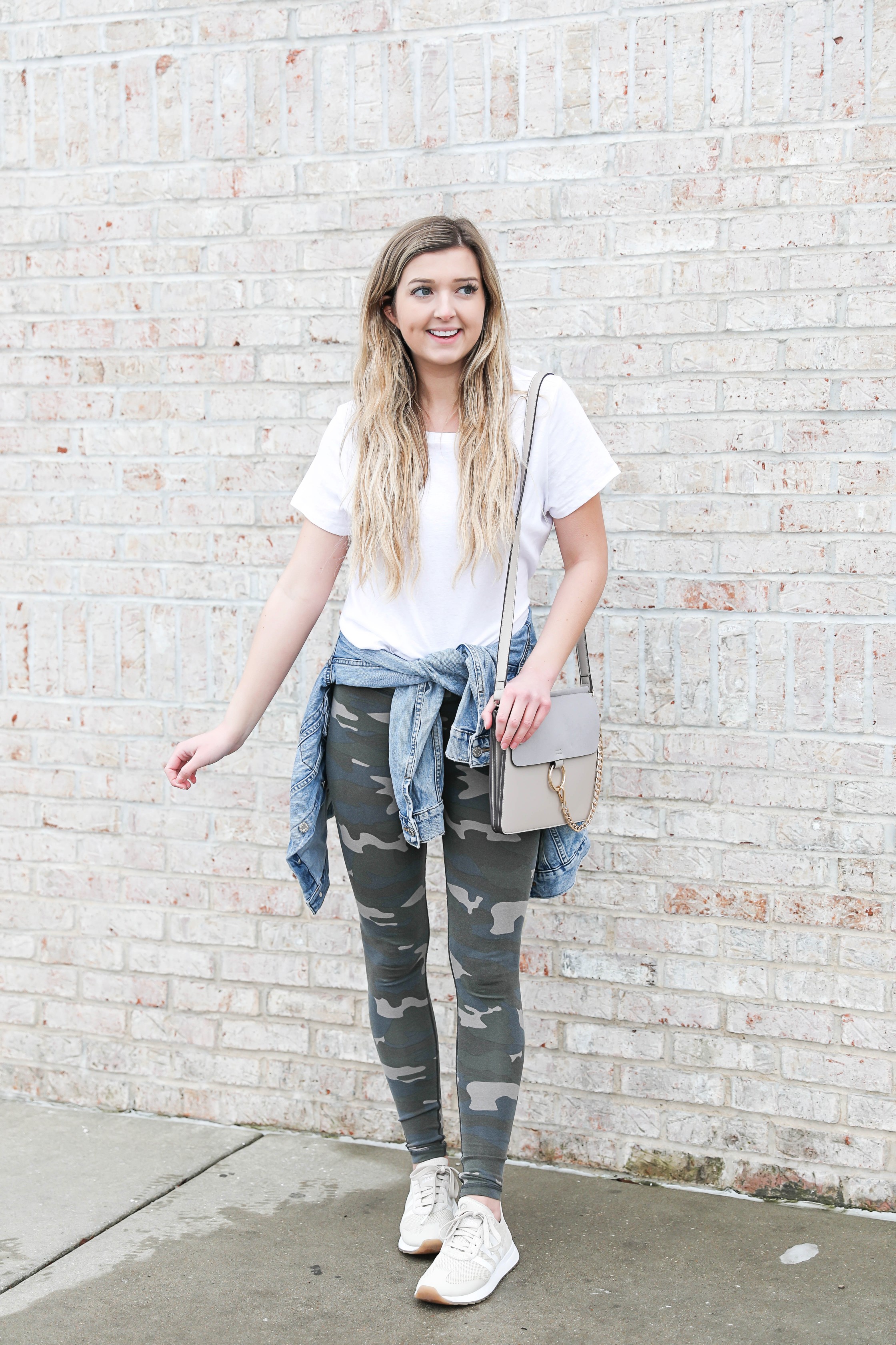 Cute camo leggings paired with a plain white tee and jean jacket! Cute way to style camo leggings, I love this trend! Camouflage is so in and makes of a cute winter outfit! This would also be cute for spring style or any time of year you want a casual look! Details on fashion blog daily dose of charm by lauren lindmark