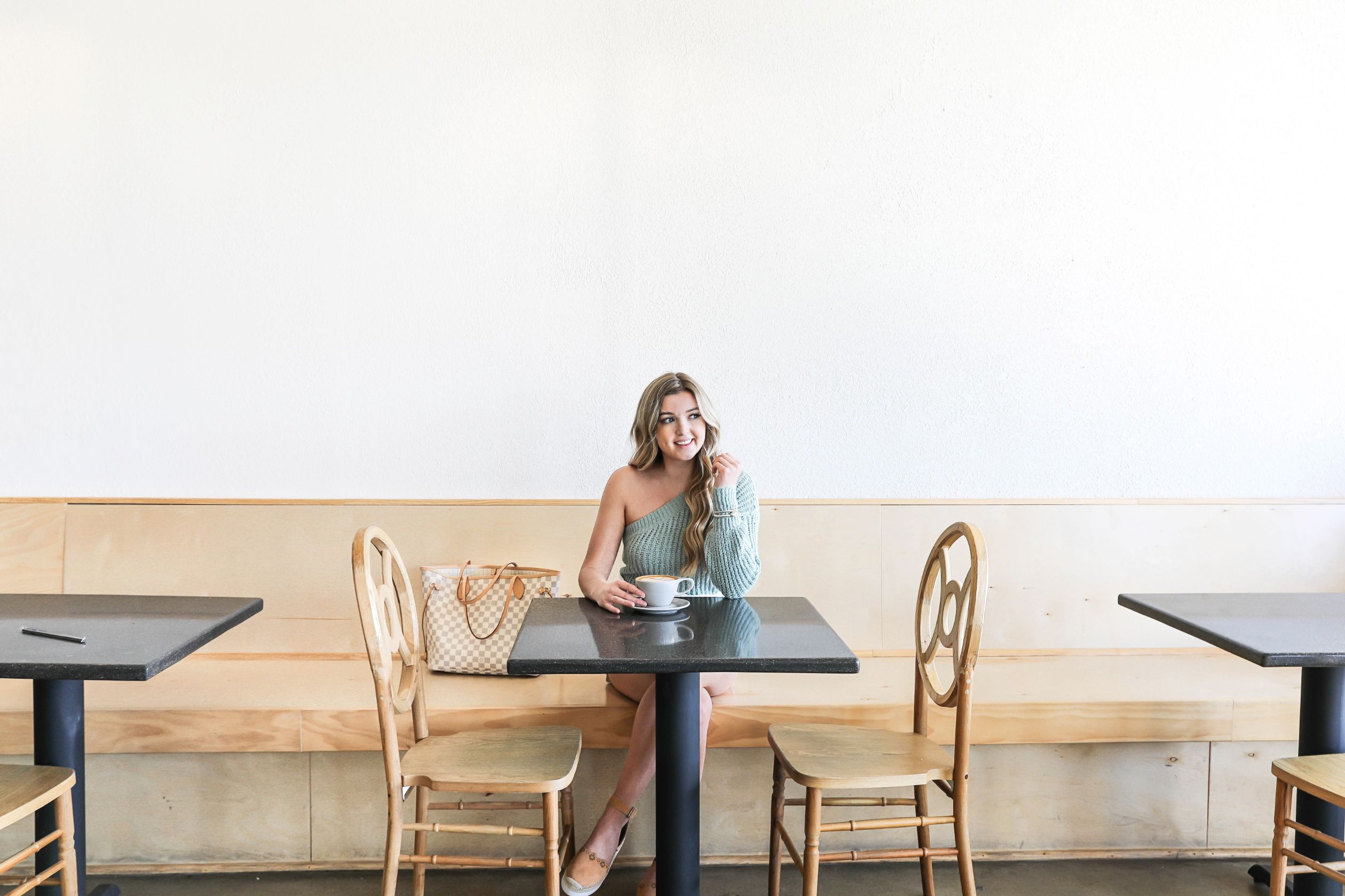 Best Kansas City Coffee shops! Cute restaurant photoshoot wearing an off the shoulder sweater! Details on fashion blog daily dose of charm by lauren lindmark